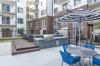 Picnic Area with a Gas Grill and a Big Green Egg® at Spoke Apartments in Atlanta, GA